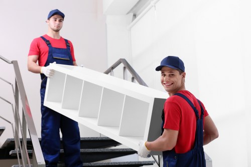 Furniture collection team handling bulky items in a Northwood home