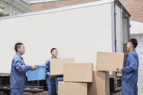 Local removals team loading furniture into a van