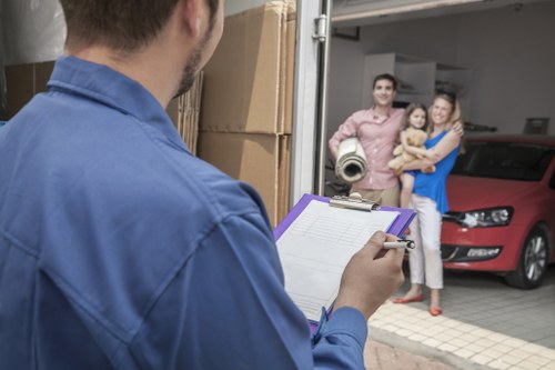 Loading furniture into a van on a Northwood residential street