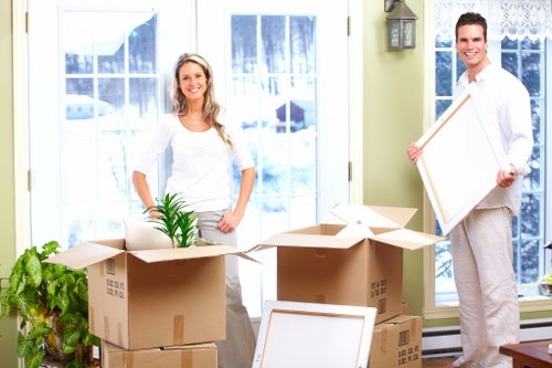 Packed moving boxes and furniture loaded into a van